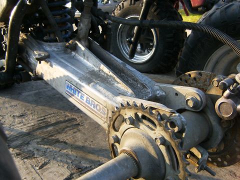 2000 Ford E350 - Close-up view of a White Bros swingarm assembly, showing the sprocket and suspension linkage.