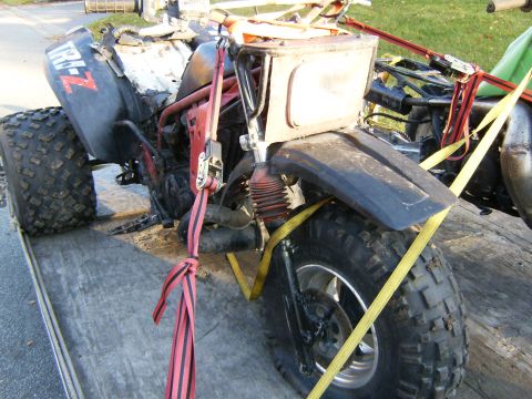 2000 Ford E350 - ATV secured with straps on a trailer, showing 'TRI-Z' branding on the fender.