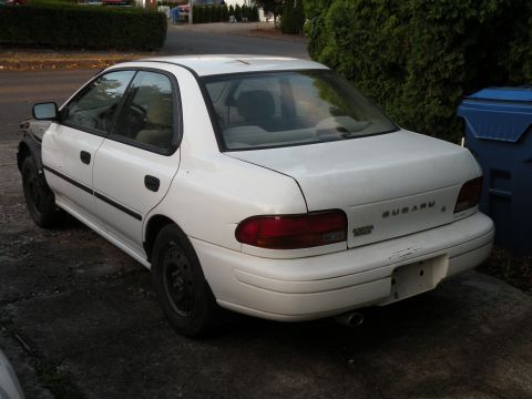 1998 Subaru Legacy - White 1998 Subaru Legacy sedan parked outside with a missing front fender.