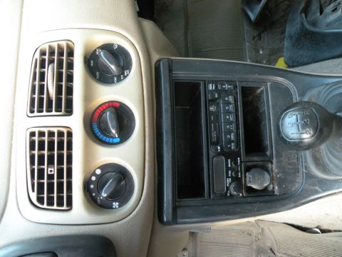 1998 Subaru Legacy - Interior view of a car's dashboard, climate controls and a gear shifter.