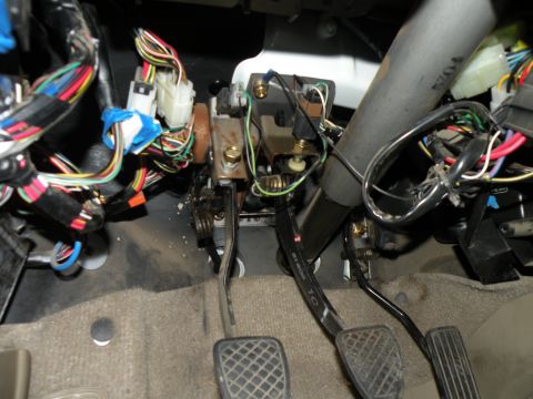 1998 Subaru Legacy - The complex wiring and pedals are visible inside the car's interior.