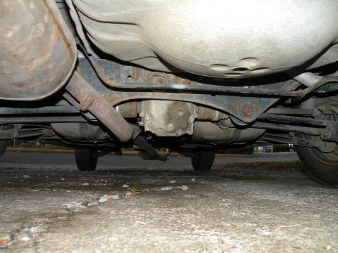 1998 Subaru Legacy - Undercarriage view of a vehicle, focusing on the exhaust and drivetrain components.