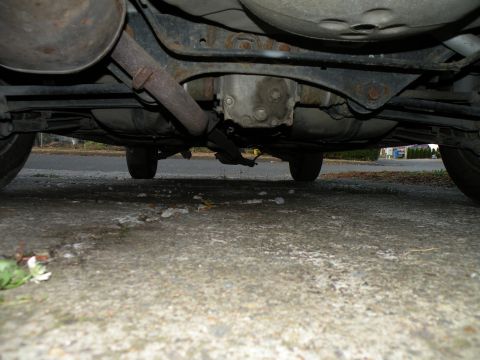 1998 Subaru Legacy - The undercarriage of a vehicle is visible, including the exhaust system and rear differential.