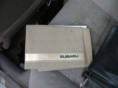 1998 Subaru Legacy - Owner's manual for a Subaru Impreza is visible on a car seat.