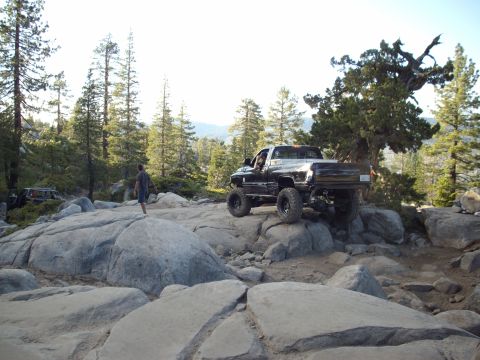 1982 Toyota 4Runner - Pickup truck off-roading on a boulder-strewn mountain path.