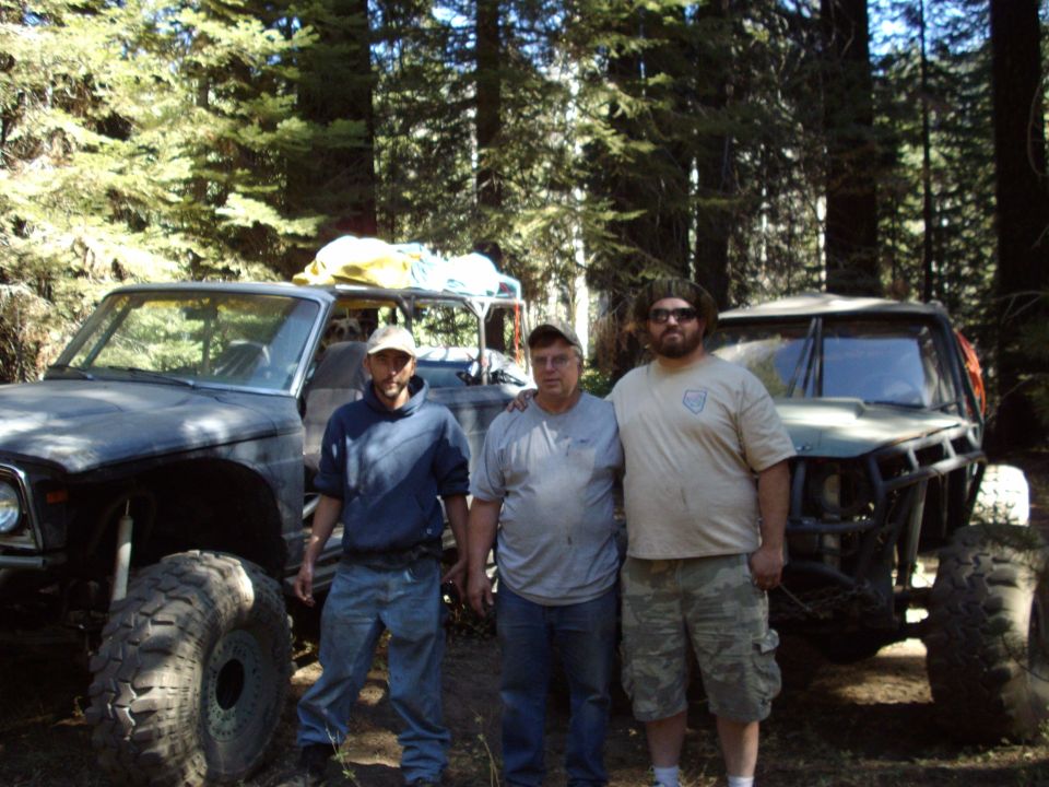 Off-road vehicles with three men in a forest setting