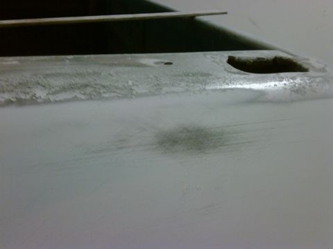 1979 Ford F-250 - The image shows a close-up of a vehicle's body panel, likely in the process of being prepped for paint.