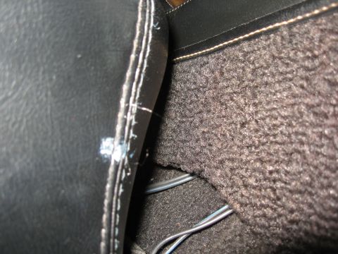 1968 Shelby GT500 - Detail of the car's interior console, highlighting the stitching on the leather trim and the textured carpet.
