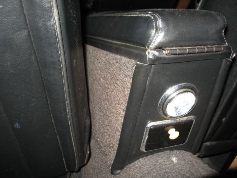 1968 Shelby GT500 - Close-up of a vehicle's interior center console, showing an ashtray and lighter socket.