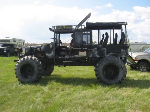 1990 Ford F-250 - This heavily modified truck features large off-road tires and a canvas-covered passenger area.