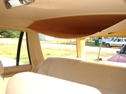 1984 Ford LTD - Station wagon interior with visible headliner damage and two vehicles seen through the rear window.