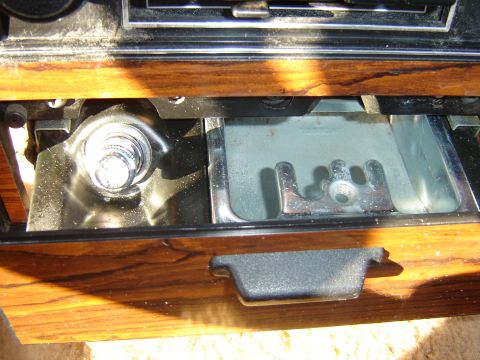 1984 Ford LTD - Close-up of the interior ashtray and radio controls, wood grain trim.