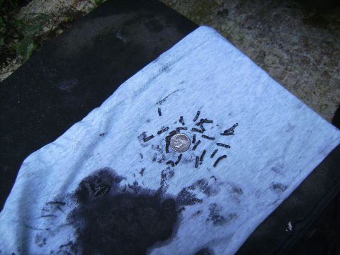 1996 Ford F-250 - Metal shavings and a dime are visible on a rag, likely from a vehicle's transmission pan.