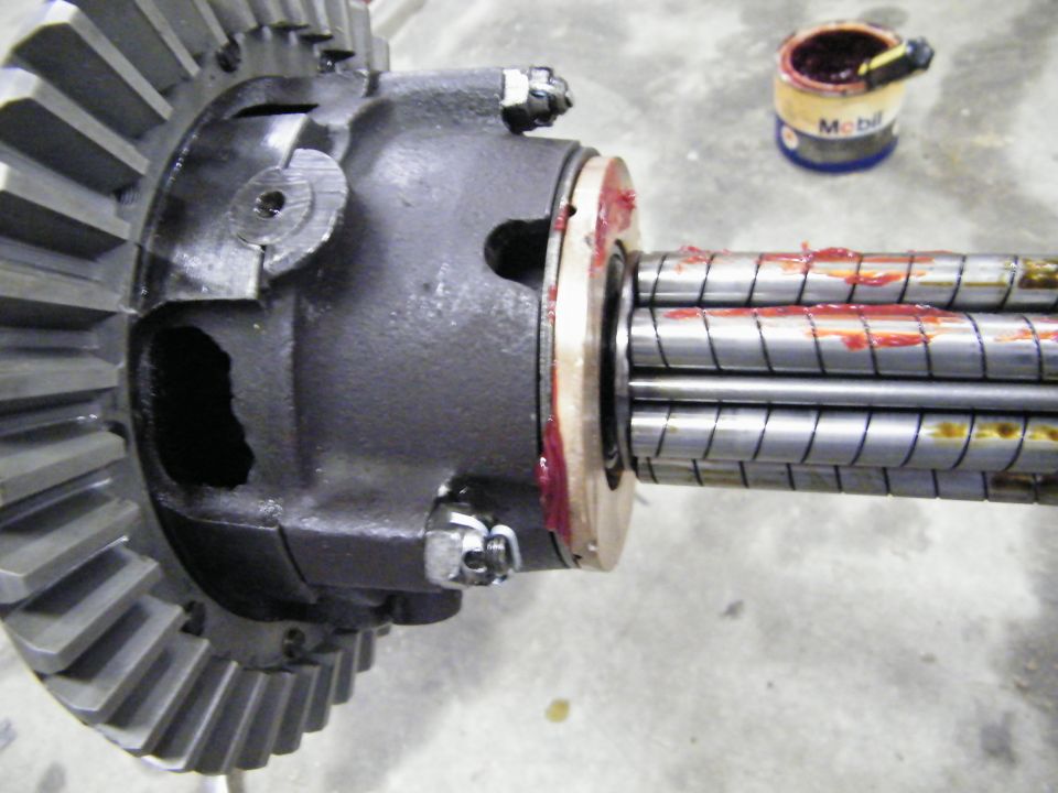 Bevel ring gear and housing with red-greased splined shaft on concrete floor