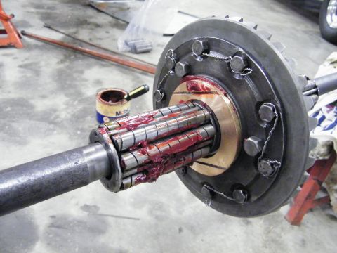 1912 Ford Model T - Differential and axle assembly with roller bearings coated in red grease, ready for installation.