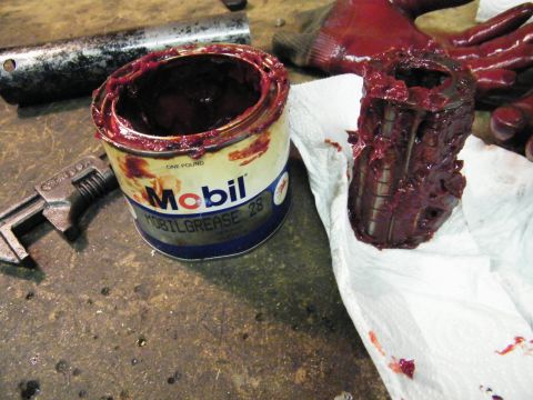 1912 Ford Model T - Mobilgrease 28 can and a greased bearing, likely for a vehicle repair.