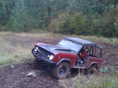 1968 Ford Bronco - A 1968 Ford Bronco navigates a challenging muddy off-road course.