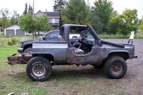 1988 Chevrolet Blazer - Modified 1988 Chevrolet Blazer with off-road tires and snorkel, parked next to another vehicle.