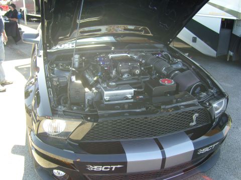 2007 Ford Mustang - This black Ford Mustang features a prominent supercharger and racing stripes, with SCT branding visible on the front bumper.