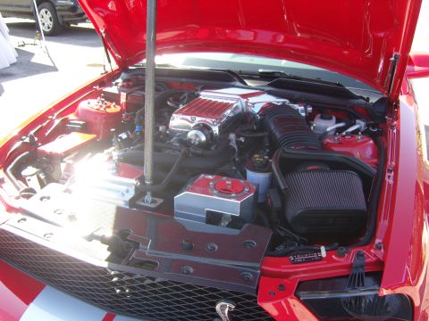 2007 Ford Mustang - Engine bay of a 2007 Ford Mustang shows a polished supercharger and custom air intake system.