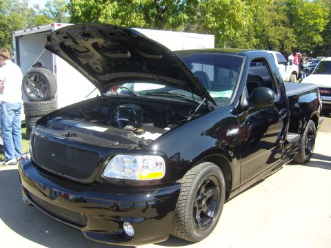 2007 Ford Mustang - A black 2007 Ford F-150 Lightning pickup truck is displayed with its hood open, showing the engine bay.