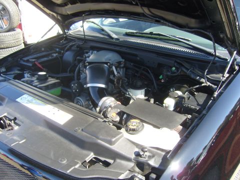 2007 Ford Mustang - Engine bay details with various components and hoses.