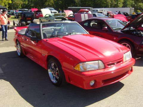 2007 Ford Mustang - A red convertible Ford Mustang is parked at an outdoor car show.