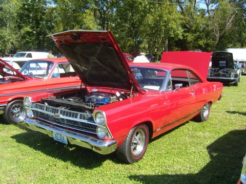 2007 Ford Mustang - A red 1967 Ford Fairlane GT is displayed with its hood open at an outdoor car show.