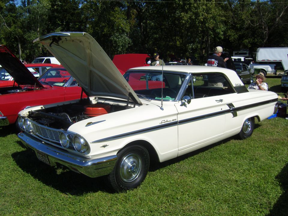 White 1962 Ford Fairlane 500 coupe with hood open, parked on grass