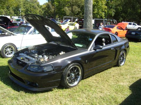 2007 Ford Mustang - Dark grey 2007 Ford Mustang coupe with hood open at a car show event.
