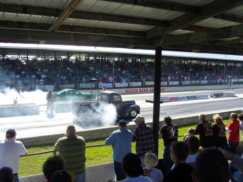 2007 Ford Mustang - Spectators watch as a black pickup truck performs a burnout at Beech Bend Raceway.