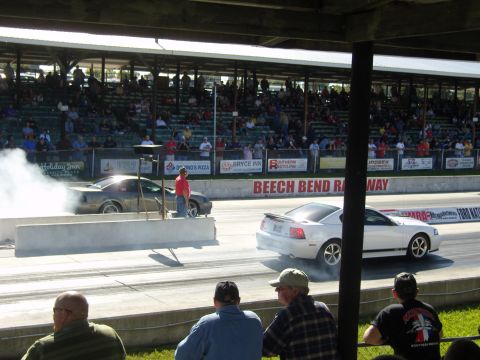 2007 Ford Mustang - Two Ford Mustangs compete at Beech Bend Raceway, with one performing a burnout.