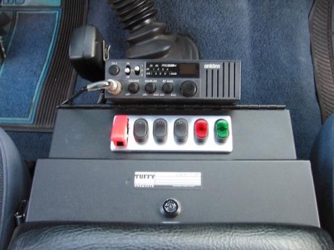 1985 Ford Bronco - Vehicle interior showing a CB radio and a panel with multiple switches, mounted on a console.