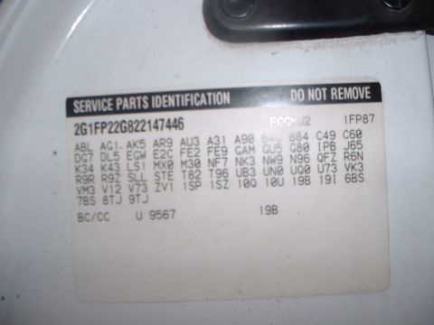 2000 Ford Crown Victoria - Close-up of a GM Service Parts Identification sticker applied to a white painted panel, headed "DO NOT REMOVE" and listing VIN 2G1FP22G8221…