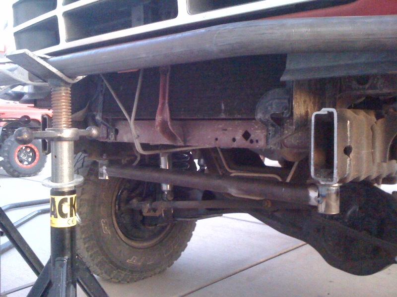 1989 Ford Bronco front suspension with jack stand, showing frame and steering components