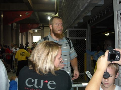 1979 Ford F-150 - Event attendees are seen near a gate, with some wearing team merchandise.
