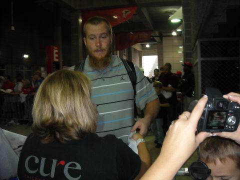 1979 Ford F-150 - A man with a beard interacts with people, one of whom is wearing a shirt with the word 'cure' on it.