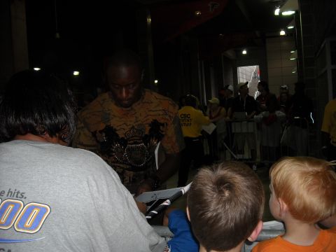 1979 Ford F-150 - A crowd watches as a man signs autographs at an event.