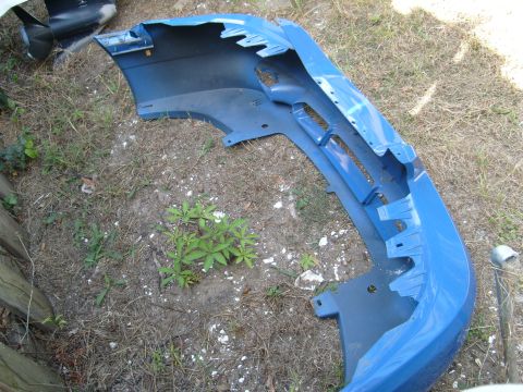1992 Ford Bronco - A blue car bumper is shown outdoors on the ground.