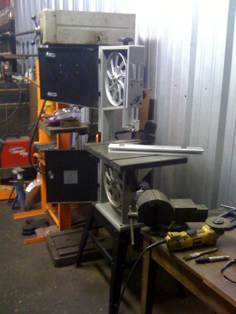 1994 Jeep YJ - A bandsaw is set up in a workshop, with a vise and grinder visible on the workbench.