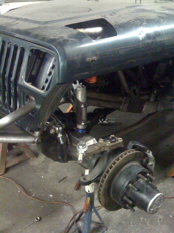 1994 Jeep YJ front axle with suspension modifications, including a new steering stabilizer and custom control arms