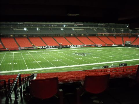 1979 Ford F-150 - The empty seats of a football stadium are visible, along with the field and a banner displaying 'Atlanta Falcons'.