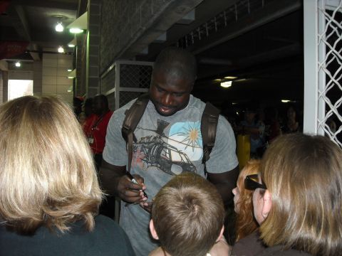 1979 Ford F-150 - A man signs autographs for a crowd of fans.
