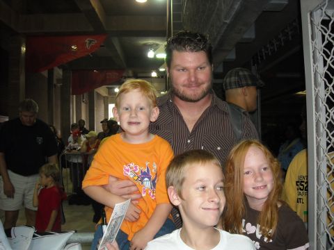 1979 Ford F-150 - A man and three children are photographed together at an indoor event.