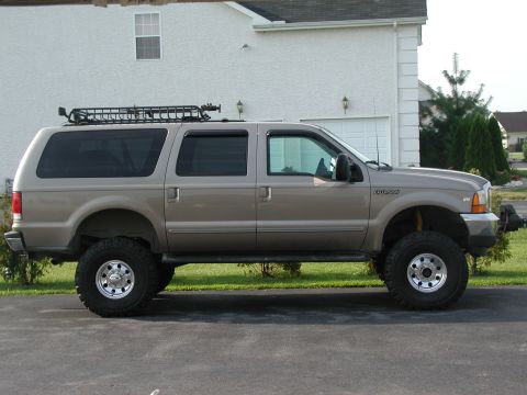 2000 Ford Excursion - Lifted 2000 Ford Excursion SUV shown from the side with a roof rack installed.
