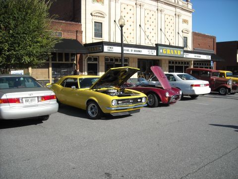 1979 Ford F-150 - Several cars are parked in front of a building with a marquee that reads "GRAND".