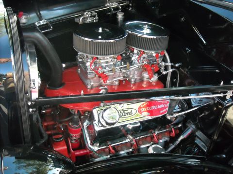 1979 Ford F-150 - The engine bay features a Ford 351 Cleveland engine with prominent dual carburetors and red detailing.