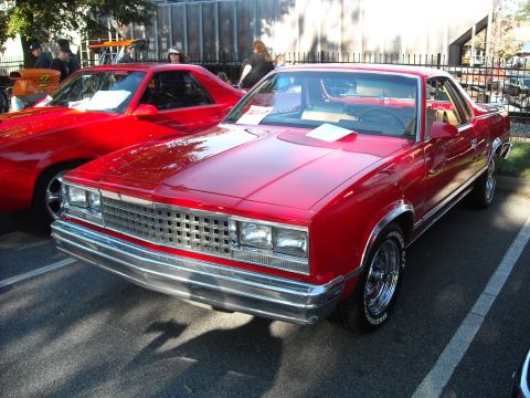 1979 Ford F-150 - Front view of a red coupe, likely a 1978 model, parked next to another red vehicle.