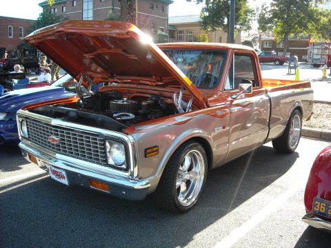 1979 Ford F-150 - A custom pickup truck is displayed with its hood open at an outdoor event.