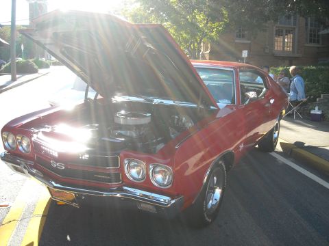 1979 Ford F-150 - A red 1970 Chevrolet Chevelle SS is displayed with its hood open, revealing the engine compartment.